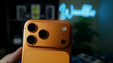 iPhone 17 Pro Max in cosmic orange in front of the Walker neon sign