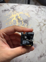 Teardown reference photo of an opened Apple 20W adapter sample - internal components; units sold are new and box packed