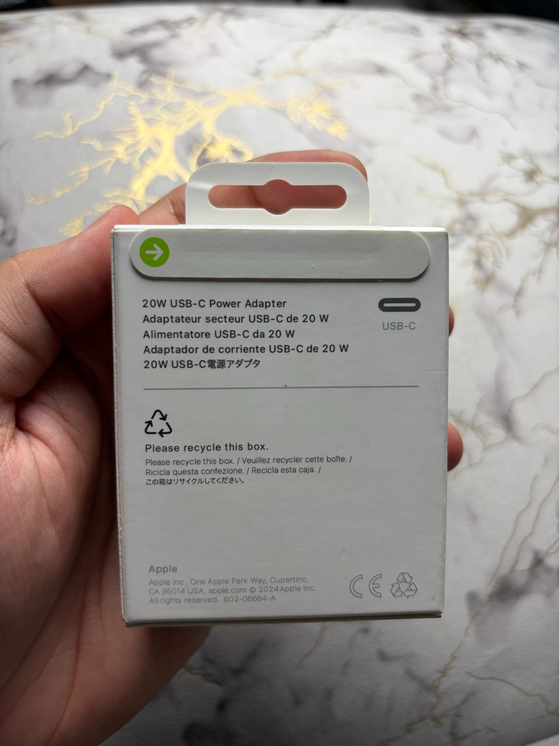 Actual Apple 20W USB-C Power Adapter packaging - rear panel and paper pull tab
