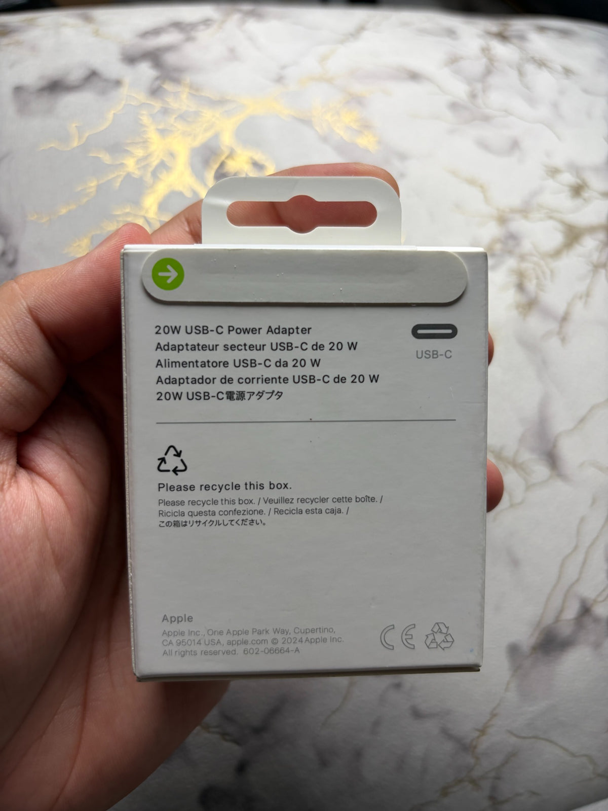 Actual Apple 20W USB-C Power Adapter packaging - rear panel and paper pull tab